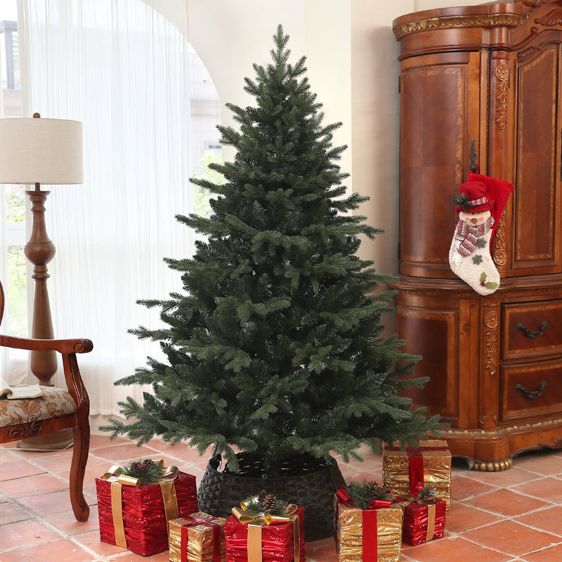 Bare 6ft spruce Christmas tree in a living room beside a wooden cabinet with red gift boxes