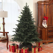 Closer view of the bare 6ft spruce Christmas tree next to a wooden cabinet with a hanging stocking