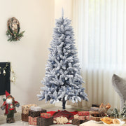 Flocked tree in a living room with wrapped gifts and a Santa figure