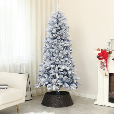 Flocked blue Christmas tree in a living room with a woven tree collar beside a fireplace
