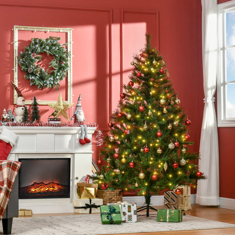 Lit Christmas tree with red baubles beside a white fireplace in a red-walled room