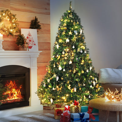 Pre-lit 6ft Christmas tree beside a fireplace with wrapped gifts around its base