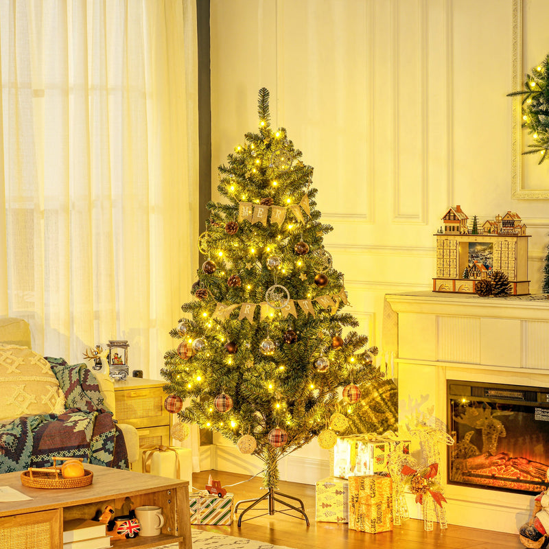 Lit and decorated Christmas tree beside a fireplace in a cosy living room