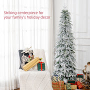 Slim snowy tree beside an armchair with wrapped presents