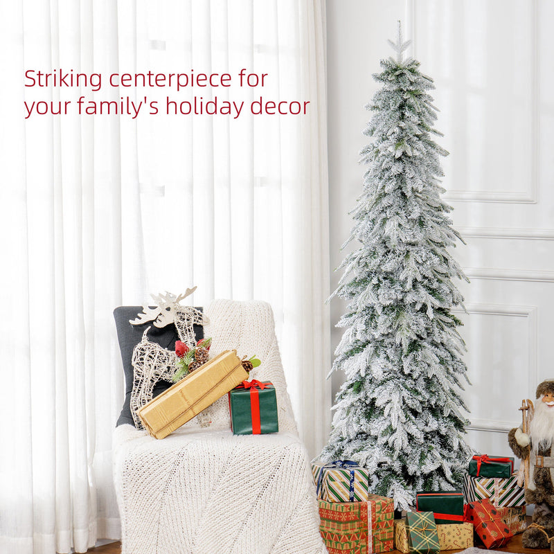 Slim snowy tree beside an armchair with wrapped presents