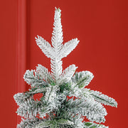 Top of the tree against a red wall showing the flocked tip