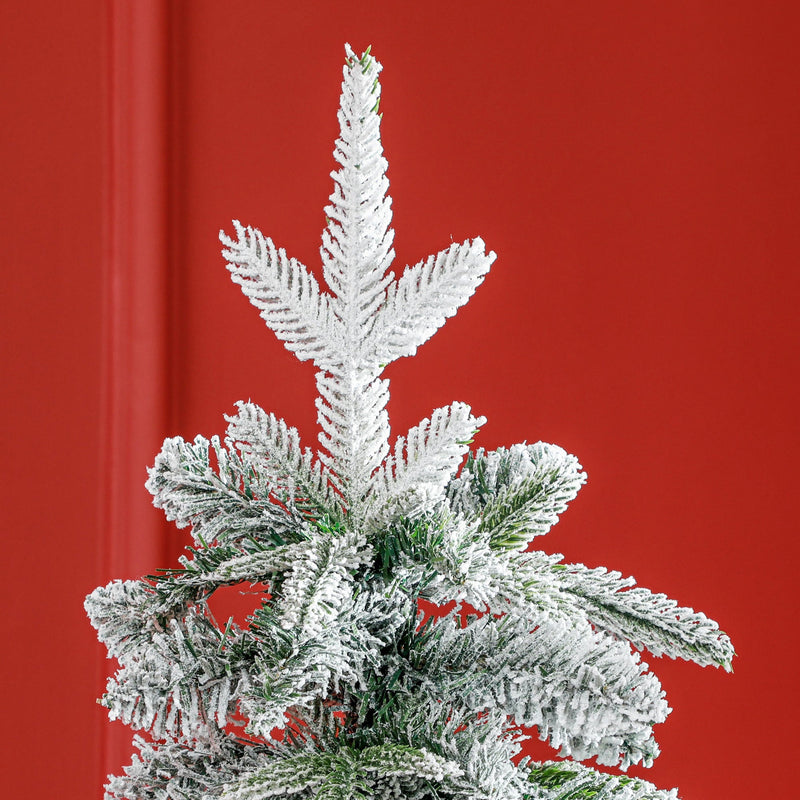 Top of the tree against a red wall showing the flocked tip