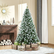 Snow flocked tree in a living room beside a fireplace with wrapped presents below