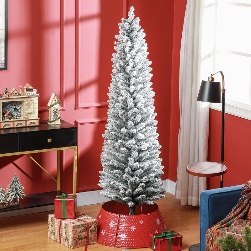 Snow-flocked 6ft pencil Christmas tree in a red living room with a red tree skirt and gifts