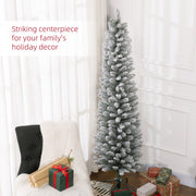 Snowy pencil Christmas tree beside a white armchair and gifts with a striking centrepiece caption