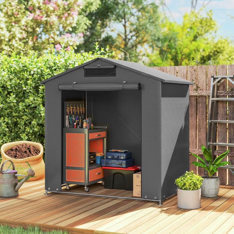 Small dark grey shed on decking with a tool trolley and tools inside