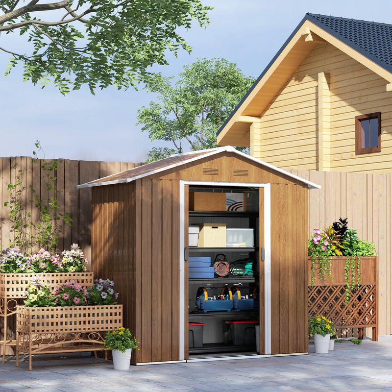 The wood effect metal shed in a garden with its doors slid open, showing boxes and tools stacked on shelving inside