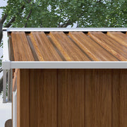 Close-up of the wood effect roof panels meeting the white eave trim above the wall