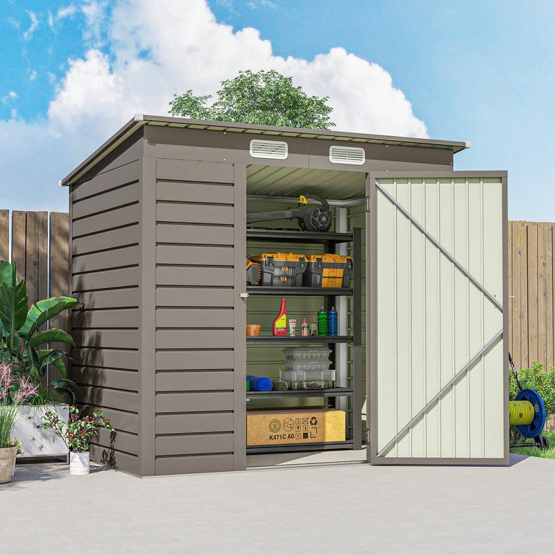 Light grey metal garden shed on a paved patio with its single door swung open beside a hose reel