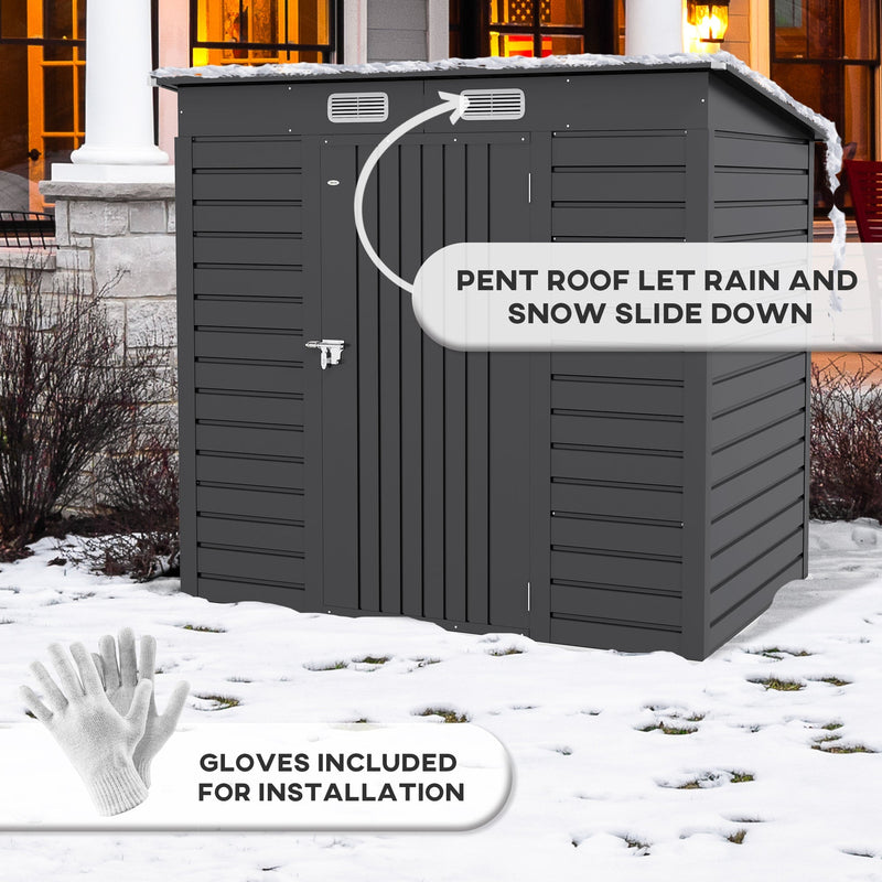 Grey metal shed with snow on its pent roof and the gloves included for installation