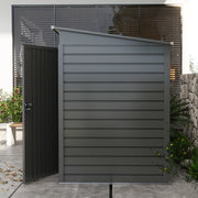 Side view of the grey metal shed with its door open, showing the sloping pent roof