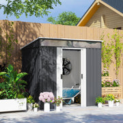 The grey shed in a garden beside a wooden fence with the doors open and a wheelbarrow parked inside