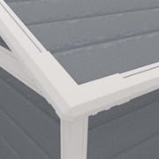 Close-up of the white roof trim and grey plastic roof panels at the shed corner