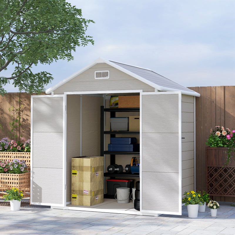 Plastic garden shed on a patio with both doors open showing shelving and boxes inside