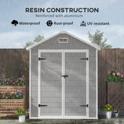Apex roof shed standing in rain, labelled resin construction reinforced with aluminium
