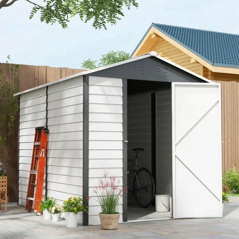 Metal garden shed with the door open next to a ladder, bicycle and wooden cabin