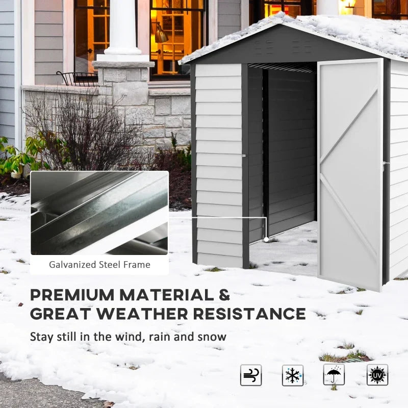 White metal garden shed standing in snow with a galvanised steel frame close-up