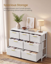 White corduroy chest with drawers open showing folded clothes and accessories