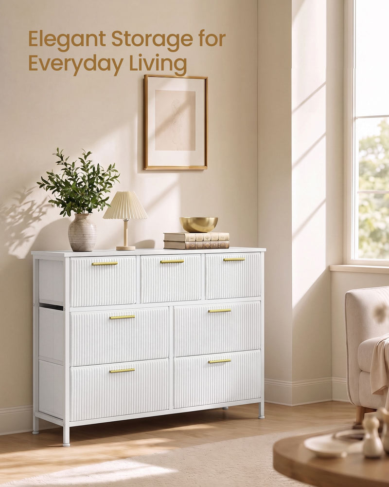 White corduroy chest of drawers styled in a living room beside a sunny window