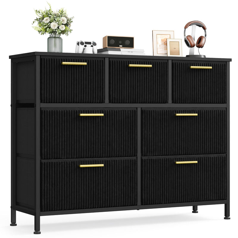 Black 7-drawer corduroy chest of drawers with gold handles on a white background
