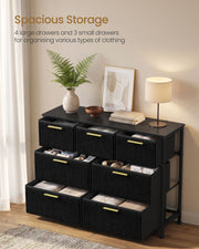 Black corduroy chest with drawers open showing folded clothes and accessories