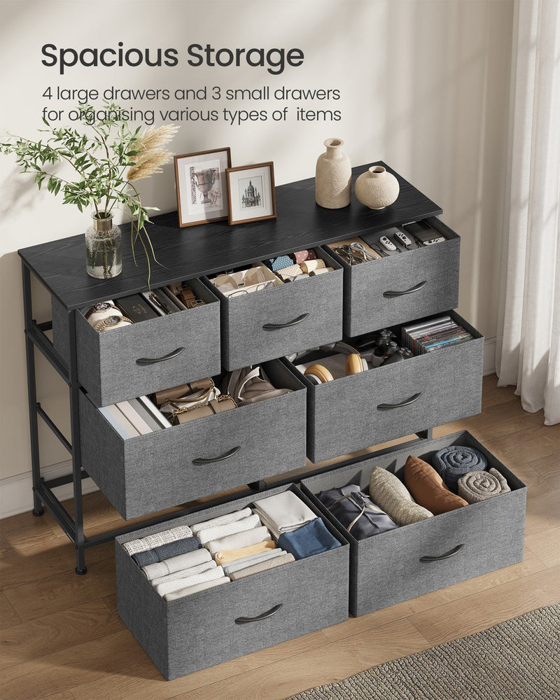 Open fabric drawers filled with folded clothes in the 7-drawer chest