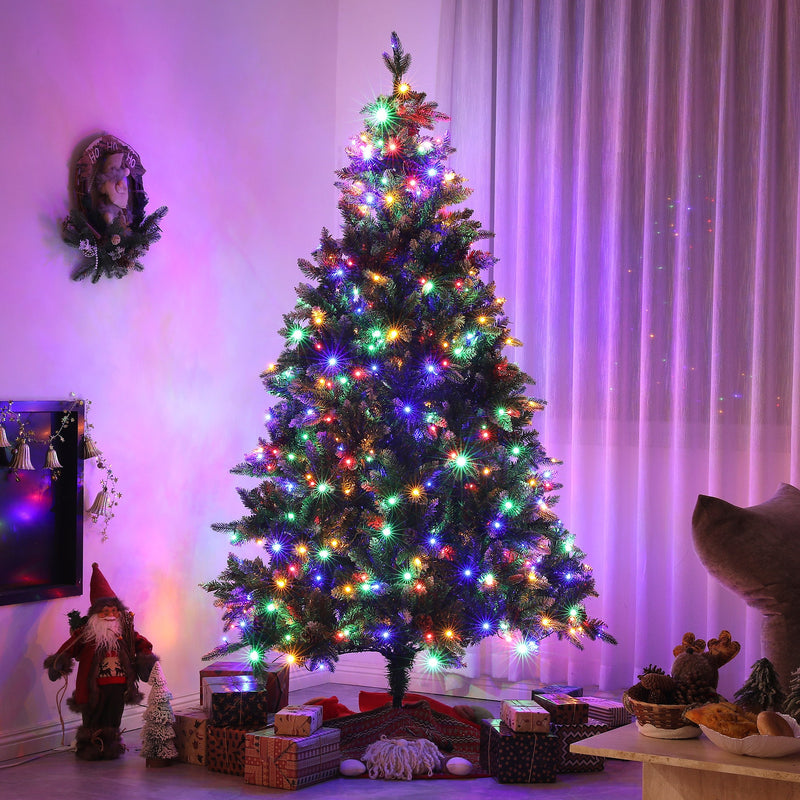 Pre-lit 7ft Christmas tree glowing with multicolour lights in a purple-lit living room