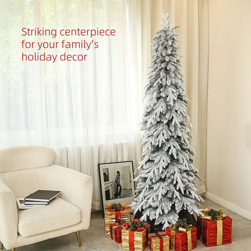 Slim snowy tree beside an armchair with wrapped presents