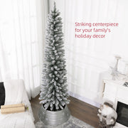 Snowy pencil Christmas tree in a silver tree skirt by a window with a striking centrepiece caption