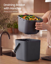 Strainer basket being lifted out to drain liquid from food scraps before disposal