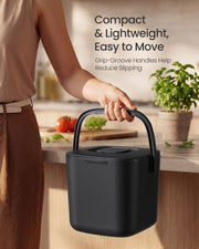 Woman carrying the Songmics compost bin by its handle in a kitchen
