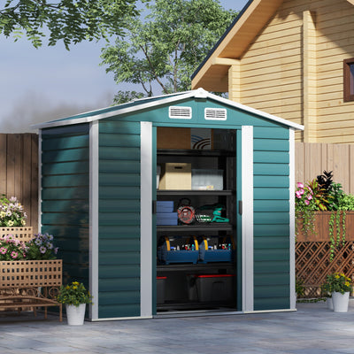 Green 7x4ft metal shed in a garden with its sliding doors open, showing boxes and tools stored inside