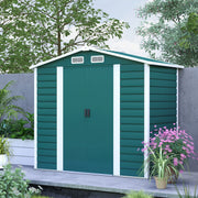 Green 7x4ft metal shed with white corner trims on a patio beside planted borders