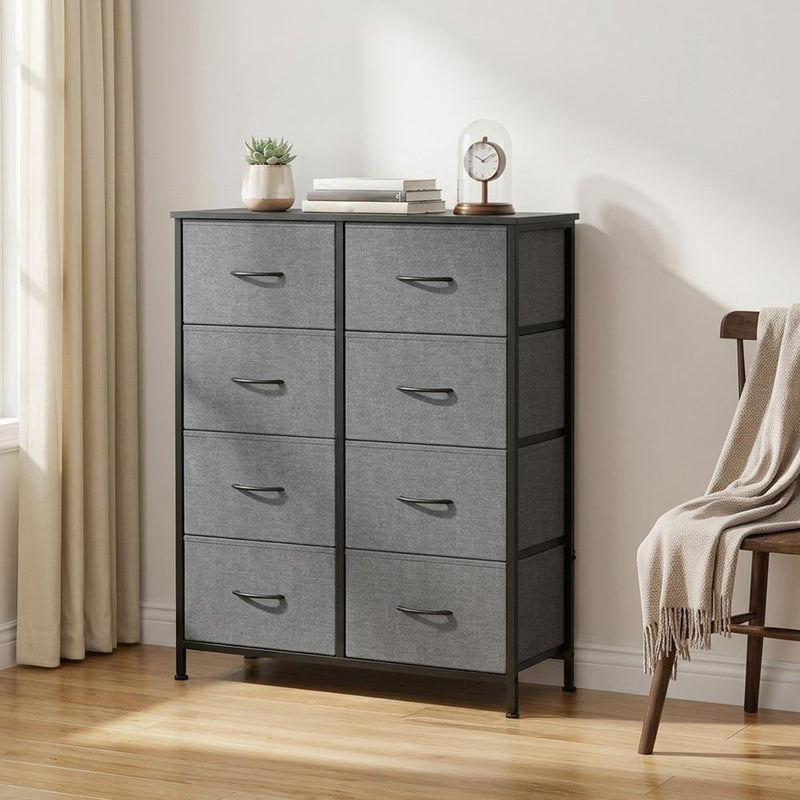 Slate grey 8-drawer chest of drawers by a curtained window with a plant and clock on top