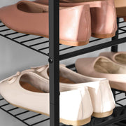Close-up of ballet flats resting on the black slatted wire shelves and upright post