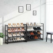 Two 4 tier black metal shoe racks placed side by side along a hallway wall, filled with shoes