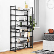 The black shoe rack stacked as one tall 8 tier tower in a bedroom, holding vases, books and plants