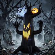 8 ft spooky tree inflatable lit up at night in a graveyard scene with skulls