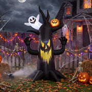 Spooky tree inflatable displayed in a fenced garden with skeleton props and fairy lights
