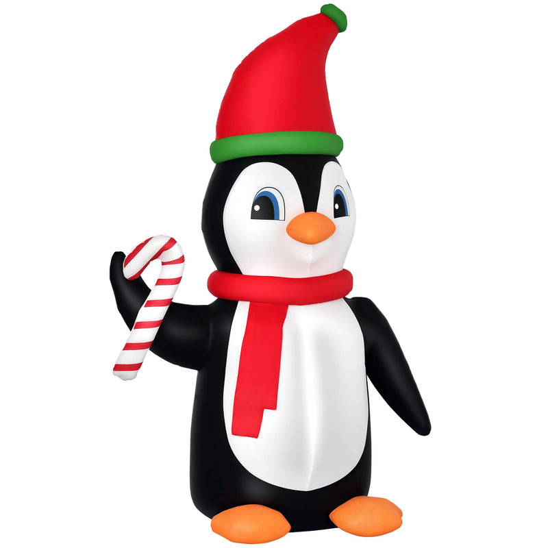 Second studio shot of the inflatable penguin holding a candy cane on white