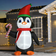 Lit inflatable penguin in front of a house with fairy lights at dusk