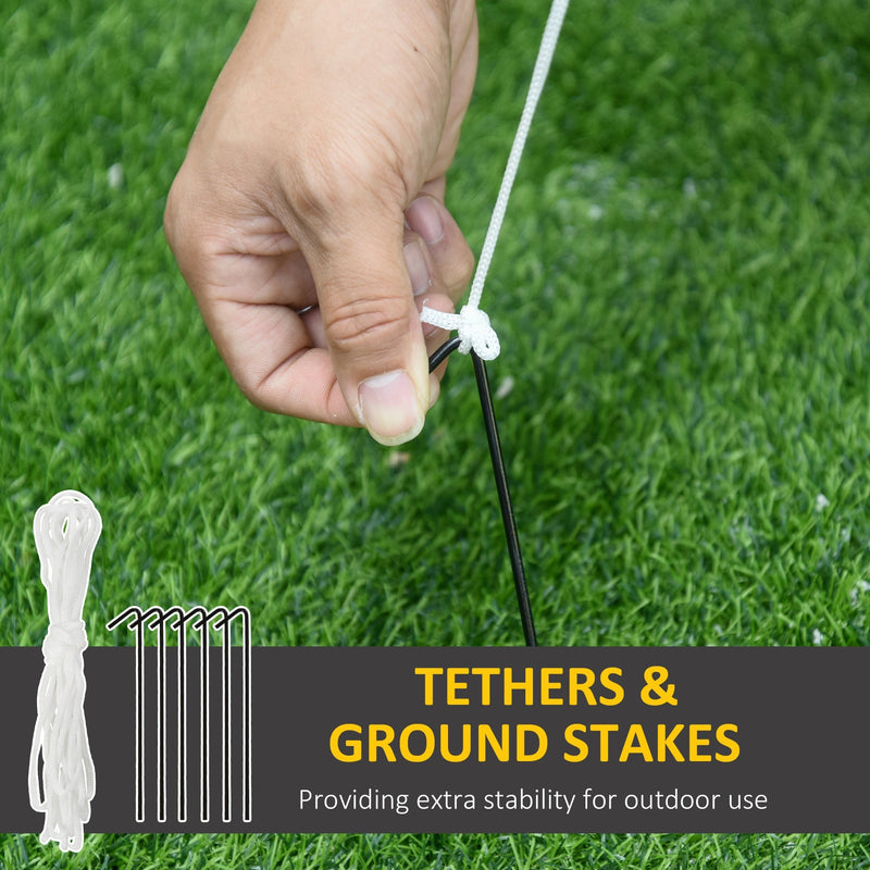 Hand tying a white tether rope to a ground stake in grass with tethers and ground stakes callout