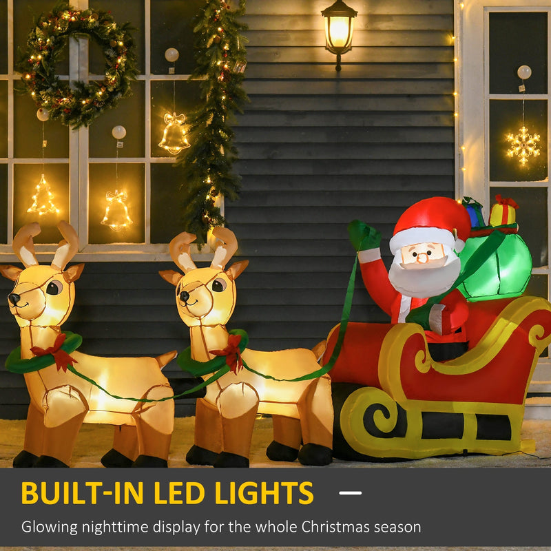 Inflatable Santa and two reindeer glowing with built-in LED lights in front of a dark house