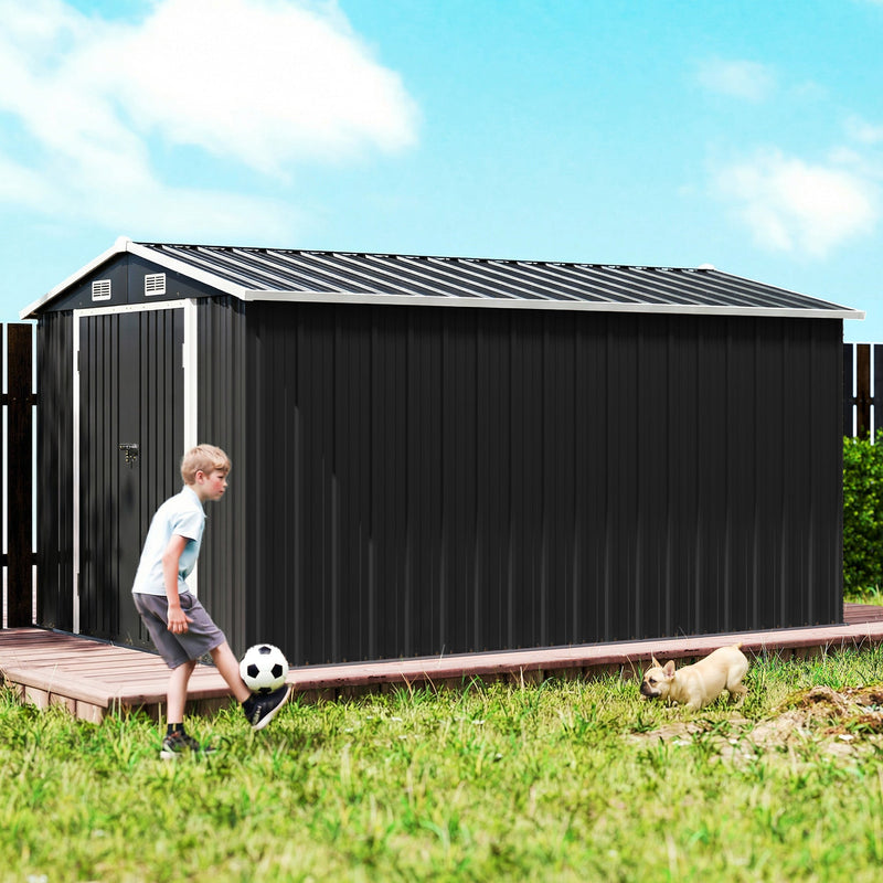 Side view of the long dark grey metal shed on a garden deck