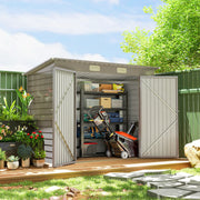 Metal shed in a garden with both doors open showing shelving, a mower and boxed tools